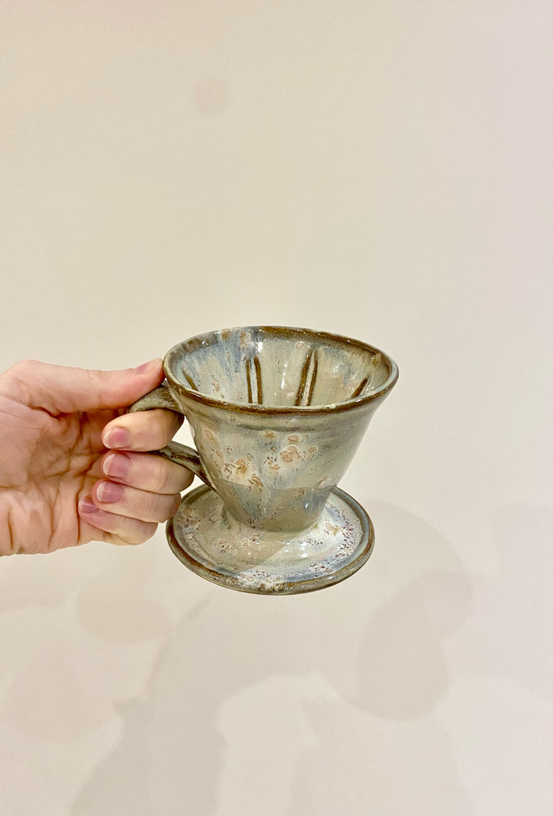 Handmade cream coloured coffee pour-over with textured glaze.